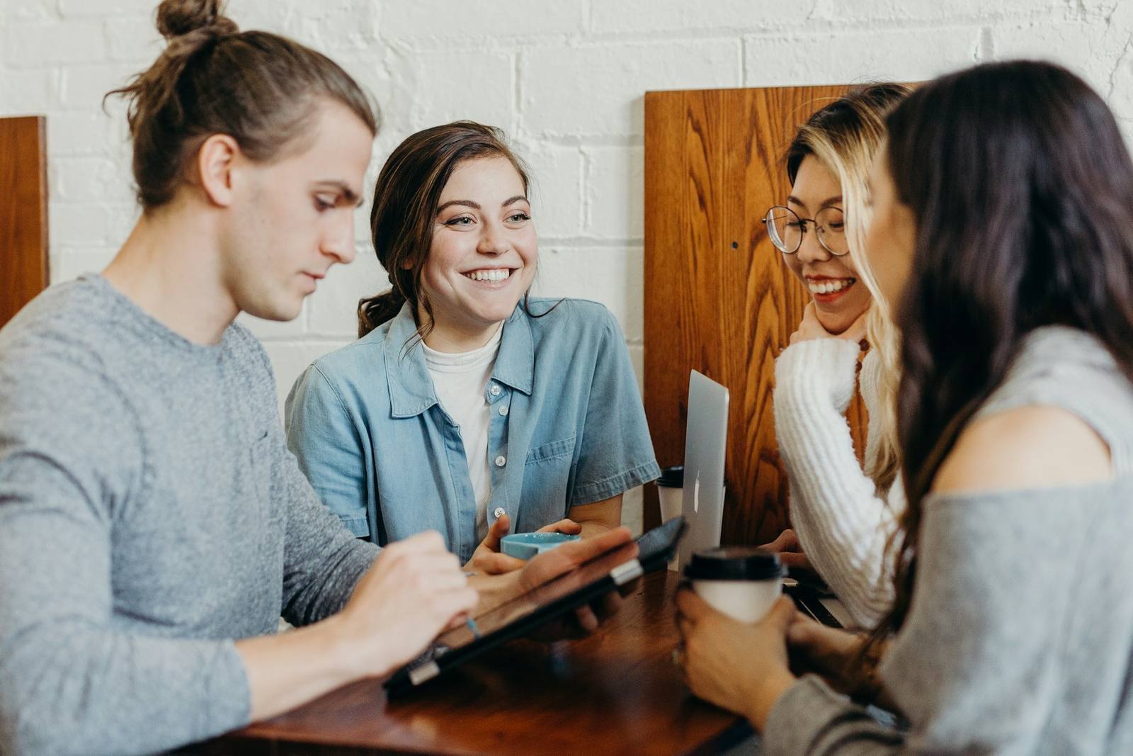 Colleagues smiling together around a café table