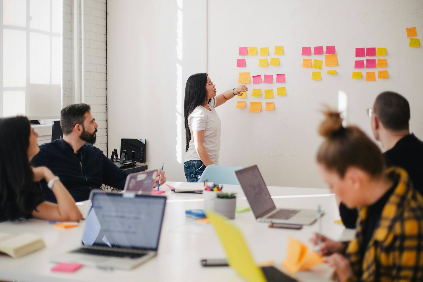 A team planning together with sticky notes on a whiteboard
