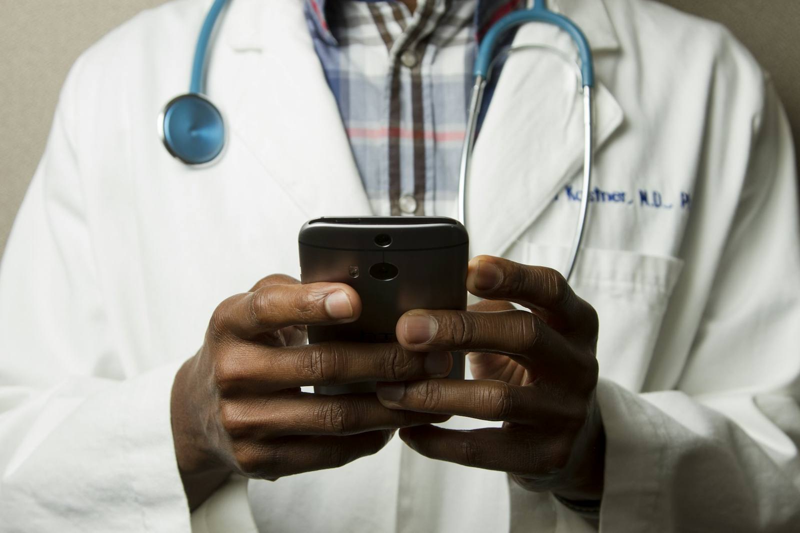 A healthcare professional checking a phone