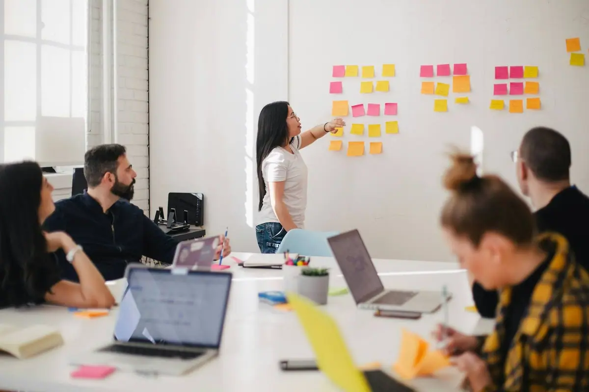 A team planning together with sticky notes on a whiteboard