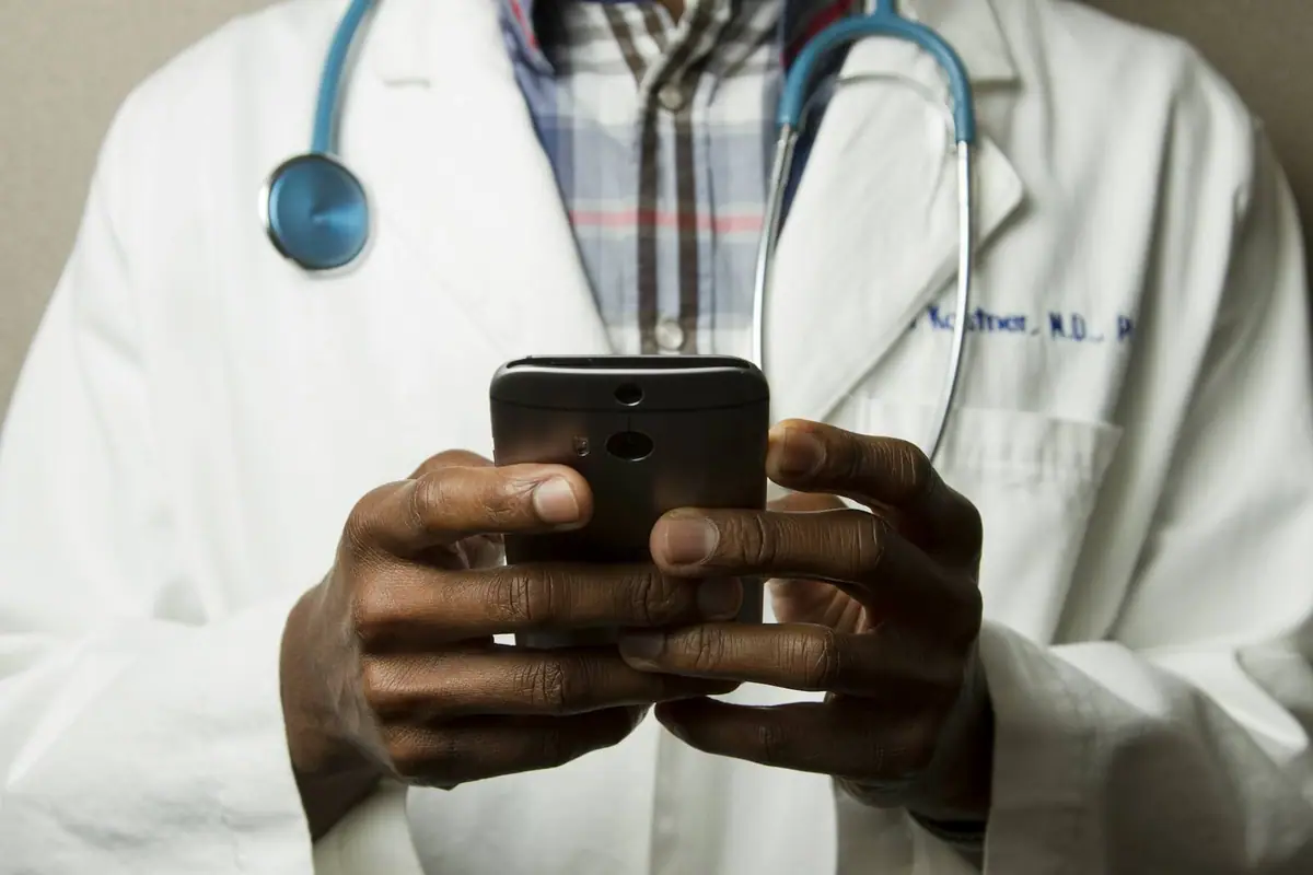 A healthcare professional checking a phone
