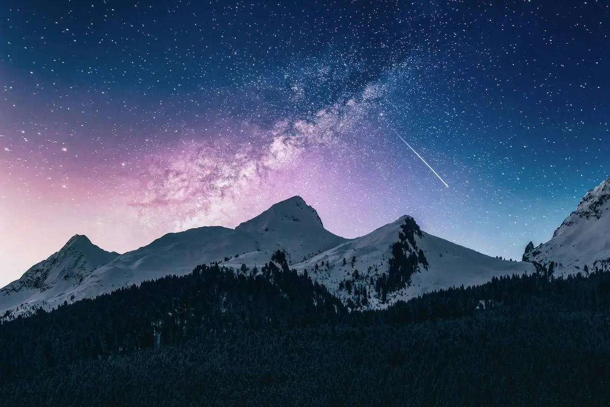 A starry sky above a mountain ridge
